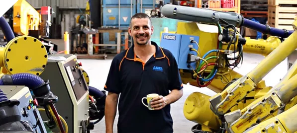 Man Smiling While Drinking Coffee — AMM Engineering in Hemmant, QLD